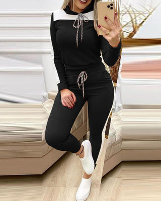 Casual fun pop - Stylish black tracksuit with decorative rope details, showcasing an elegant and trendy attire for a relaxed yet fashionable look.