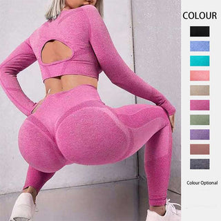 Vibrant seamless workout set with long sleeve crop top and high-waist leggings in eye-catching pink color. Features stylish cutout detail on the back of the top and form-fitting silhouette for active lifestyle.