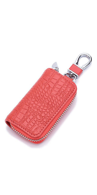 Compact red leather key holder with zipper compartment and metal clasp, compact accessory for organized car keys and wallet storage.