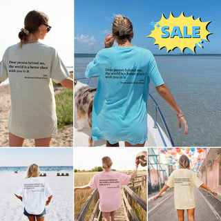 Women's fashion graphic tees with inspirational text and vibrant colors, featuring a beach and sale promotion backdrop.