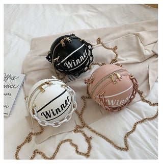 Three small round bags with the "Winner" logo on a white fabric background. The bags come in black, pink, and white colors with gold-tone chain straps, exuding a stylish and trendy vibe.