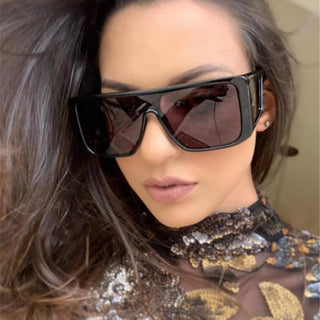 Stylish retro sunglasses with multiple mirrored surfaces, worn by a fashionable woman with long dark hair.