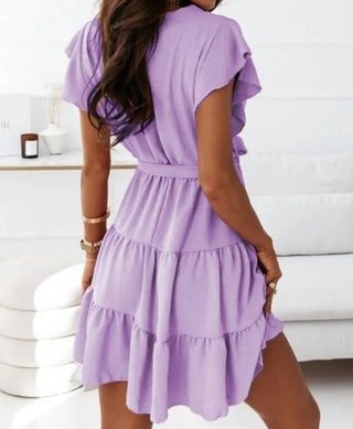 Stylish v-neck strap waist swing dress in purple hue with layered ruffled skirt, showcased against a plain white background.