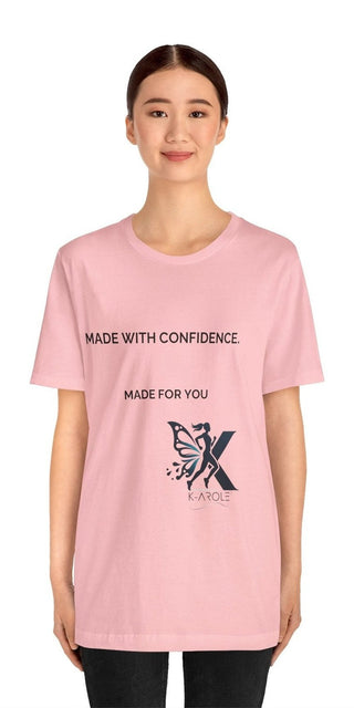 Casual pink t-shirt with confident slogan and butterfly graphic pattern. Comfortable cotton unisex design for everyday wear.