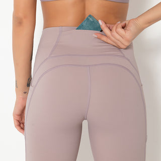 Taupe-colored women's high-waisted yoga pants with a hidden pocket, showcasing a modern, athletic design.