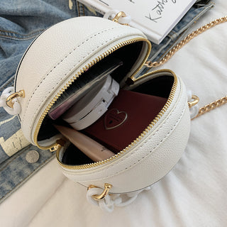Stylish round handbag with gold hardware and chain strap, featuring multiple compartments for storage and organization.
