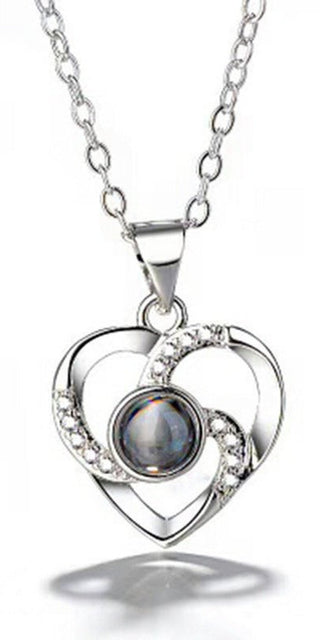 Elegant silver-toned heart-shaped necklace with a shimmering pearl-like gemstone and sparkling crystal accents.