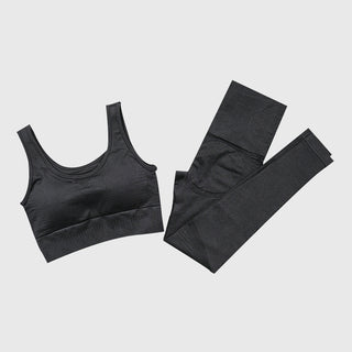 Black seamless sportswear set featuring a sports bra and leggings on a plain white background.