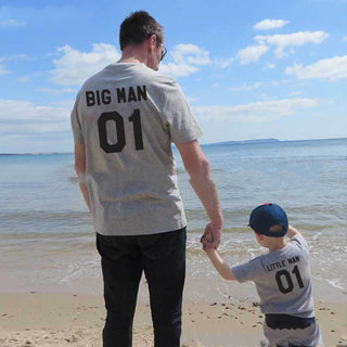Matching "Big Man 01" and "Little Man 01" t-shirts for father and son at the beach
