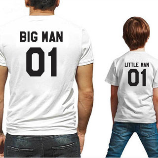 Matching family t-shirts with "Big Man 01" and "Little Man 01" printed on the back, showcasing coordinating father-son or adult-child fashion.