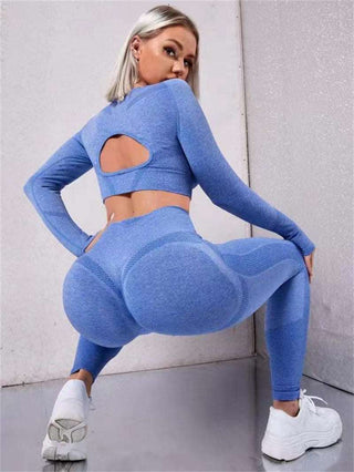 Stylish seamless workout set: long sleeve top with cutout detail and high-waist leggings in vibrant blue color. Designed for active wear and comfort.