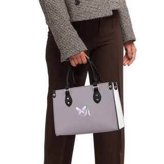 Elegant women's PU leather handbag with a stylish gray and white color scheme. The bag features a simple and sleek design with contrast black handles, perfect for accessorizing a chic, fashionable outfit.