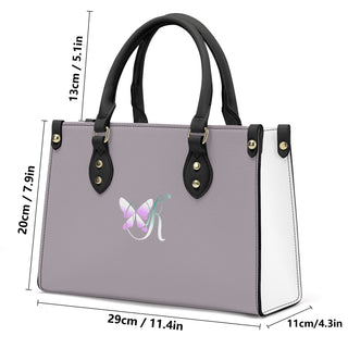Stylish gray leather handbag with black trim and butterfly logo design, featuring a modern and fashionable appearance suitable for various occasions.