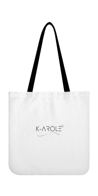 Stylish white tote bag with black handles and the K-AROLE logo prominently displayed, showcasing the versatile and trendy design of the brand's fashion accessories.