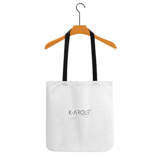 Stylish white tote bag with K-AROLE logo, hanging on a wooden clothes hanger against a plain background.