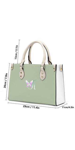 Modern mint green and white PU leather tote bag with sleek silhouette and decorative butterfly logo, perfect for stylish everyday use.