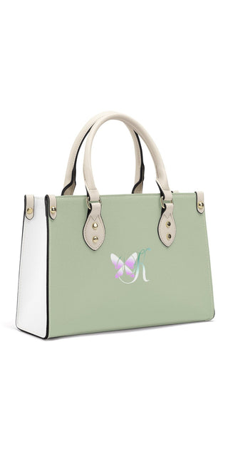 Elegant women's handbag in light green color, featuring a sleek and stylish design with gold-tone hardware accents. The handbag has a structured silhouette and a roomy interior, making it a practical and fashionable accessory.