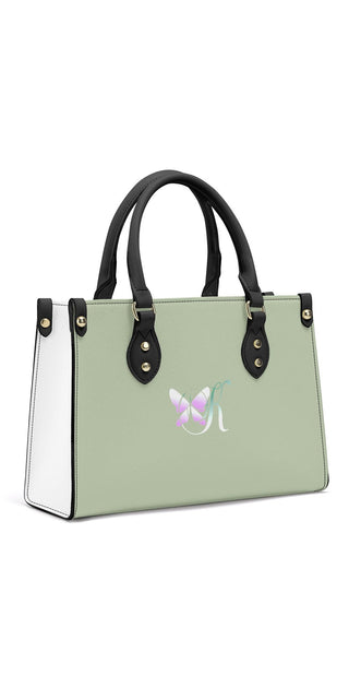 Trendy mint green women's handbag with black accents and a distinctive logo on the front. The stylish tote bag features a structured silhouette and dual top handles, showcasing a modern and sophisticated design.