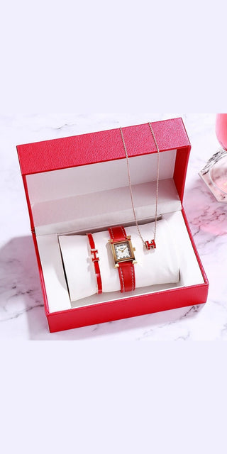 Stylish Valentine's Day women's watches in red gift box on marble texture