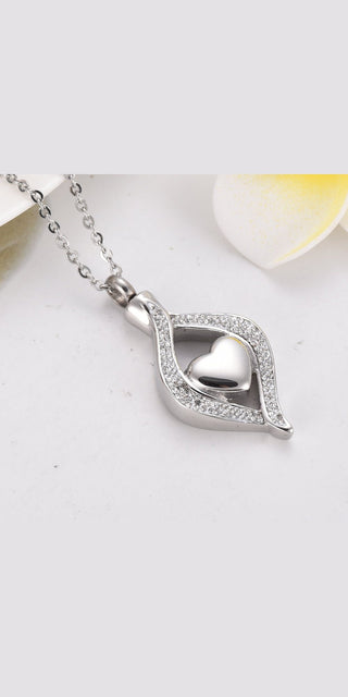 Elegant titanium steel heart-shaped ash box pendant with sparkling crystal accents, a thoughtful memento for cherished memories.