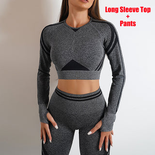 Dark grey knit long sleeve top and high-waisted legging yoga set. The outfit features a cropped top with a front panel design and complementing fitted leggings. This streamlined, seamless activewear set provides a stylish and comfortable look for yoga, fitness, or everyday wear.