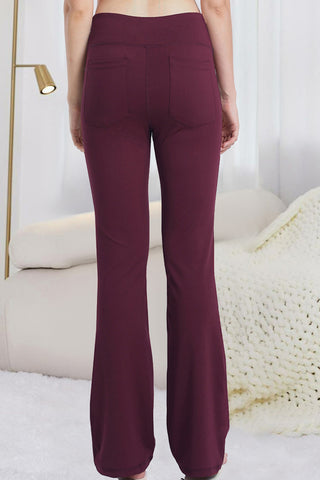 Stylish burgundy flared yoga pants with a sleek, fitted design for comfortable and trendy athleisure wear.