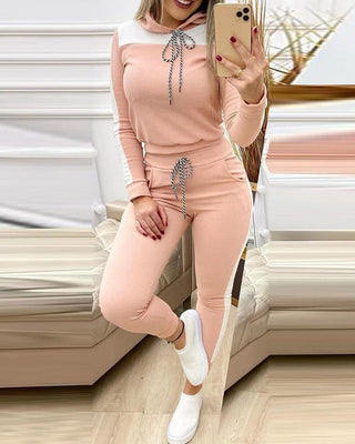Stylish casual outfit with a pink sweatshirt and matching jogger pants, showcasing a trendy and comfortable look.