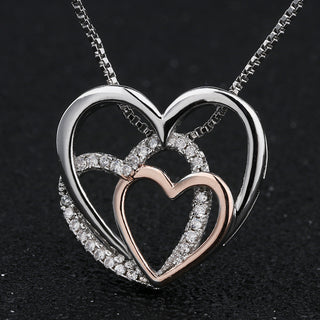 Elegant Heart-Shaped Pendant Necklace with Sparkling Accents - Silver and Rose Gold Tone Jewel Displayed on Black Background
