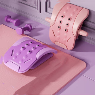 Pastel-colored lumbar vertebra massager devices on a wood floor, designed to provide soothing relief and traction for the back.