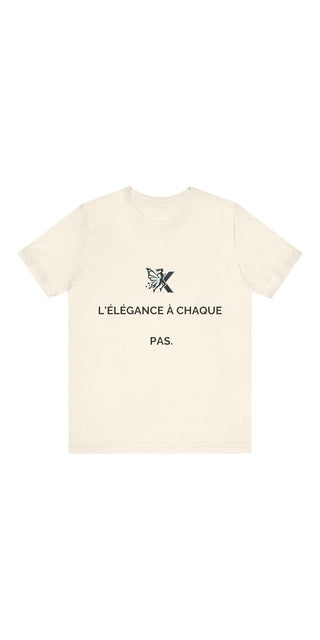 Unisex jersey short-sleeve tee with French text reading "L'elegance a chaque pas" and a butterfly motif, showcasing a minimalist, stylish design.