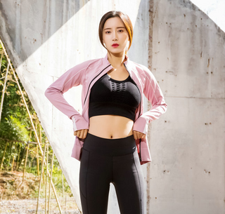 Slim-fit sportswear with stylish pink jacket, black crop top, and sleek leggings - versatile athletic attire for modern women.