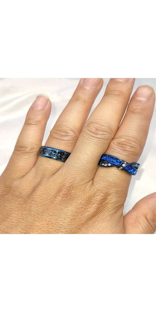 Stunning blue crystal couple rings on slender fingers, showcasing elegant style and commitment.