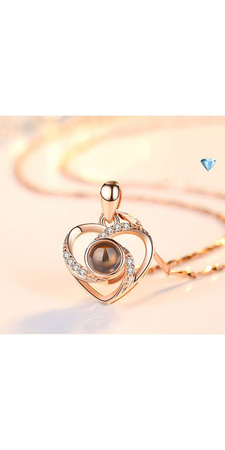 Elegant heart-shaped pendant necklace with sparkling crystals and a mesmerizing rotating charm, creating a captivating accessory for the modern K-AROLE woman.