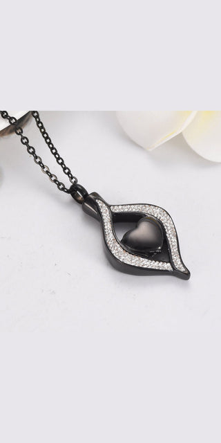 Elegant titanium steel heart-shaped ash box pendant with sparkling crystal accents, a stylish accessory for modern women.