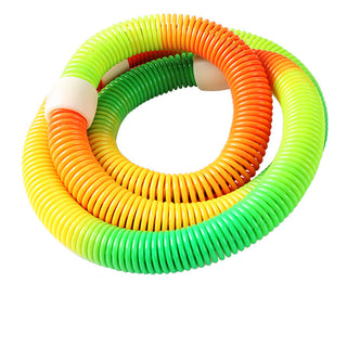 Colorful fitness hoop equipment. A variety of vibrant, flexible hoops in shades of green, orange, and yellow arranged in a spiral. The hoops are designed for home bodybuilding, fitness exercises, and weight loss.