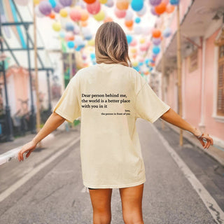 Stylish woman's t-shirt with inspirational quote and colorful balloons in the background