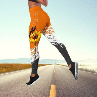 Vibrant butterfly print yoga pants on a person standing on a road surrounded by a scenic landscape