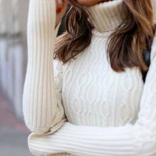 Cozy winter sweater: Warm, textured knit dress in festive white.