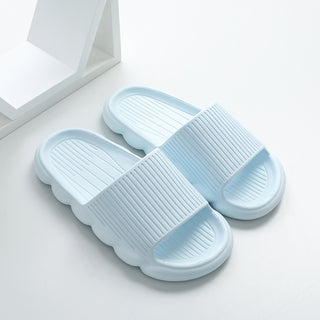 Comfortable women's home slippers with a wave-patterned, non-slip sole, displayed against a white background.