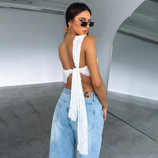 Elegant lace-trimmed backless summer top with a stylish open-back design, paired with modern high-waisted denim jeans, creating a chic and trendy streetwear look.