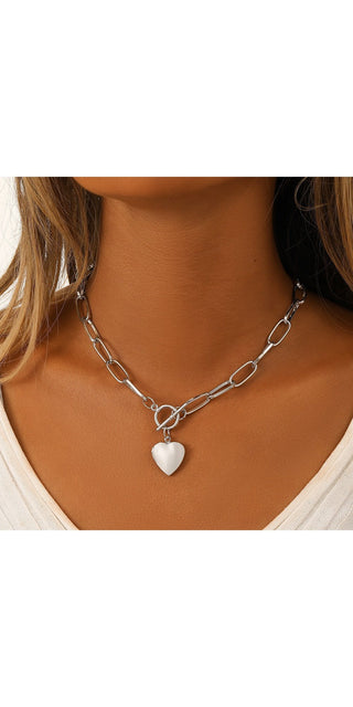 Sleek silver chain necklace with a heart-shaped pendant featured in the center, showcasing a stylish and minimalist accessory design.