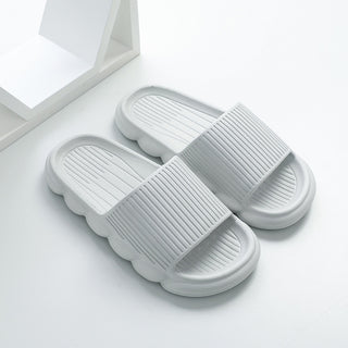 Comfortable white wave-patterned slippers with anti-slip textured soles, suitable for home, bathroom, or casual wear.