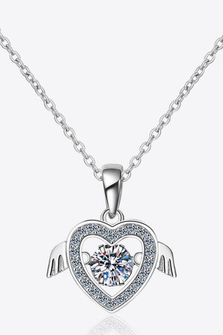 Elegant sterling silver heart-shaped pendant necklace with sparkling moissanite center stone, surrounded by a halo of shimmering cubic zirconia gems, displayed on a delicate silver chain.
