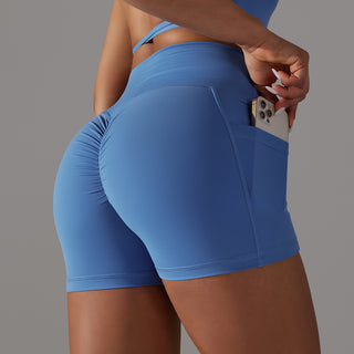 Blue athletic shorts with phone pocket design for women's fitness and sports wear.