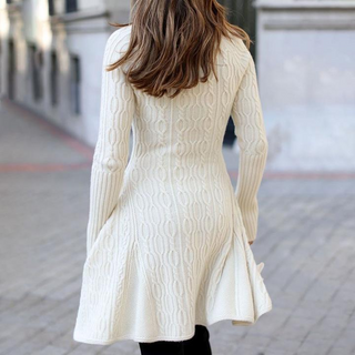 Cozy knit dress with feminine silhouette on display in image