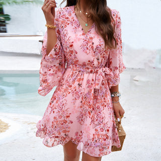 Floral-printed pink dress with ruffled sleeves and lace-up details, perfect for warm-weather fashion.