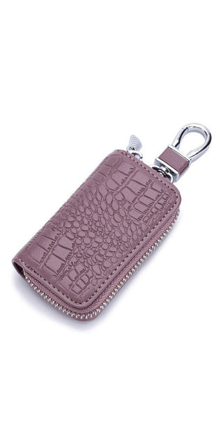 Stylish leather key holder with croc embossed pattern in lavender hue, featuring a zipper closure and a metal clip for easily attaching to bags or purses.