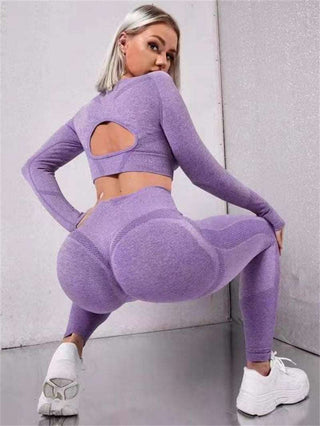 Seamless workout set with long sleeve top and high-waisted leggings in lavender hue, featuring a stylish cutout design on the back.