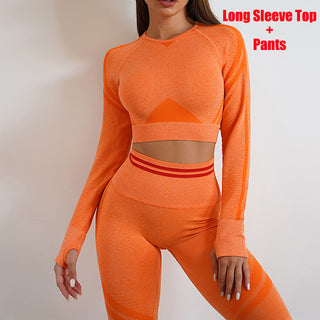 Vibrant orange athletic crop top and leggings set, featuring a long-sleeved, form-fitting design and contrasting stripe details for a stylish activewear look.