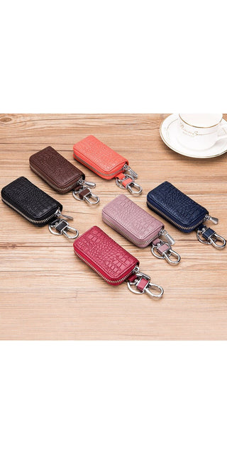 Stylish leather key holders in various colors arranged on a wooden surface. Compact and organized storage for car keys, wallets, and other small essentials. Featuring a sleek and modern design, these key pouches from the K-AROLE brand provide a practical and fashionable way to keep your daily accessories together.